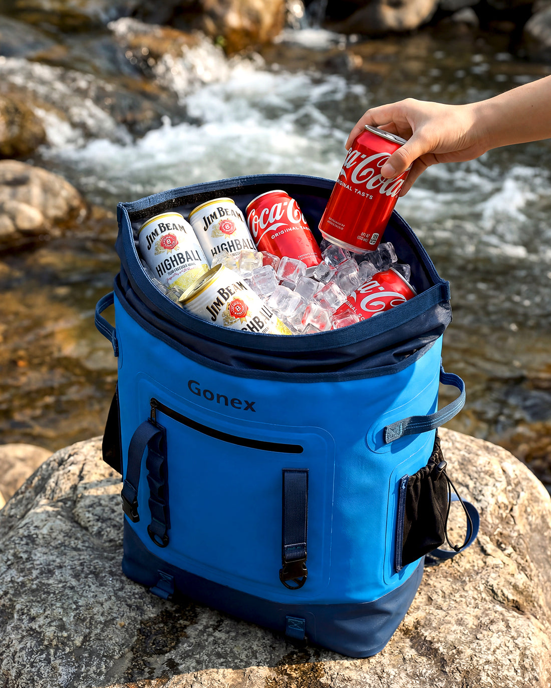 Gonex insulated cooler backpack with ice and drinks by the river